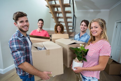 Packed moving boxes and furniture ready for collection in a Haringey property