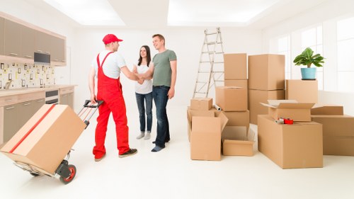 Local moving team organising items in a flat